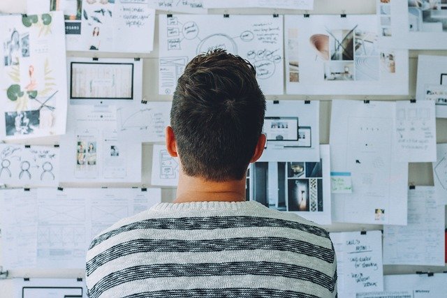 man looking at whiteboard